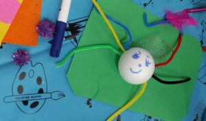 Spider created from polystyrene ball and pipe cleaners, with felt tip drawn smiling face, created with support in response to looking out for each other prompt