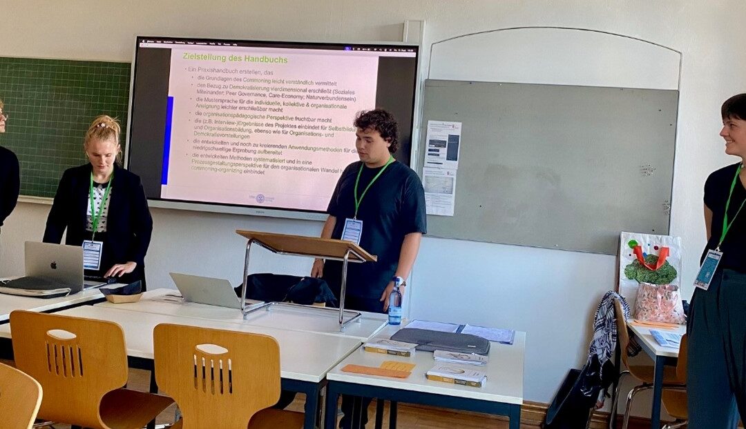 Four members of AECED Germany stand, presenting at the PBNE forum in Germany.