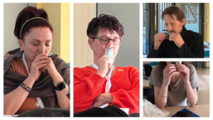 Sensing democracy-as-becoming activity where participants were given small bags of coffee. They opened them, closed their eyes, and inhaled the scent, focusing on the aroma and the emotions it evoked while again trying to quiet the analytical mind. Various participants are shown with eyes closed, focussing on the aroma of the open coffee bag.